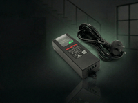 Powerbox PBBSEC-1205-4 12 V security power supply with Australian mains plug and lead on dark background.